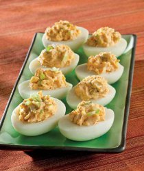 1. Cut each hard-cooked egg in half lengthwise. Scoop the egg yolks out into a small bowl.  2. Add the mayonnaise, curry sauce, lime juice, scallions, and salt to the bowl with the yolks. Mash the ingredients together until combined.  3. Fill the yolk mix